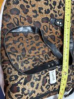 Exterior showing leopard pattern, handles, ruler for width measurement