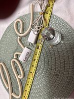 LED Love sign, power cord, ruler for scale, resin figurine visible