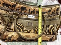Front view showing tapestry animal pattern, handles and tape measure for height
