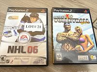 Front view of both PS2 game cases showing titles NHL 06 and Outlaw Volleyball Remixed