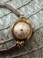 Front view showing dial, case and hands