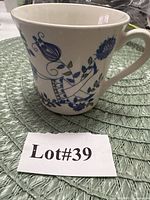 Full view of mug showing blue bird and floral pattern