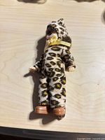 Full view of doll in leopard outfit