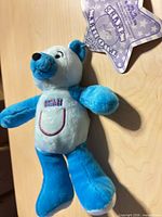 Front view of blue and white plush bear with Utah embroidery and hang tag