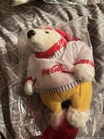 Front view of sealed Coca-Cola polar bear plush in ski attire