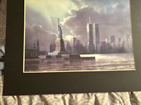 Full view of print within black mat showing Statue of Liberty and twin towers