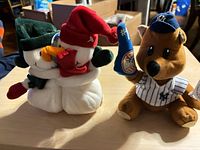 Front view of snowman and bear plush toys