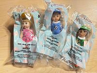 Front view of three sealed Madame Alexander Happy Meal dolls