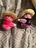 Front view of both plush bear keychains showing colors, hats, key rings
