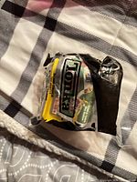 Front view of sealed Tonka dump truck toy in plastic bag