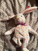 Front view of pastel floral star bunny with tag