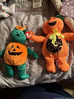 Front view of both Ty Halloween plush toys showing tags and design features