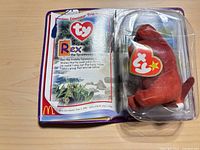 Rex the Tyrannosaurus sealed in blister card, card open-book style