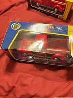 Boxed 1:24 red 1940 Ford pickup model, full package view