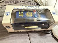 Boxed die-cast model truck top view with association branding