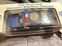 Top view of boxed diecast SUV showing association name and roof detailing