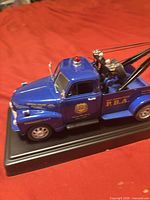 Driver side view showing New Jersey State P.B.A. markings, boom assembly, display base