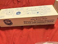Cream box showing Limited Edition New Jersey State PBA Police Car Carrier Truck text