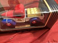 Model truck in display case showing left side and plaque