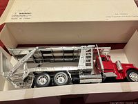 Side view of diecast Peterbilt 379 auto carrier in box