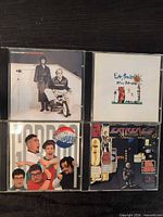 Front view of all four CD jewel cases showing cover art