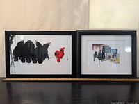 overall view of both framed prints on shelf