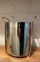 Full view of stainless steel cooler showing gold-plated side frames and reflective surface