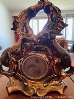 Front view showing horse motif ceramic mantel clock without dial cover