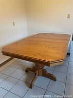 Top view of rectangular light oak dining table with chamfered corners