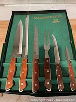 Set of five knives and fork in green flocked case