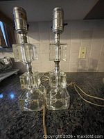 Pair of glass and chrome lamps showing overall design and height