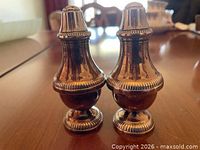Front view of both silver-plated urn-form shakers