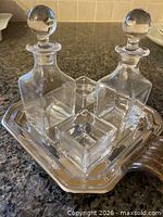 Full cruet set showing two decanters, two dishes, tray and handles