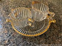 Top view of creamer, sugar bowl and underplate showing ribbed design and amber accents