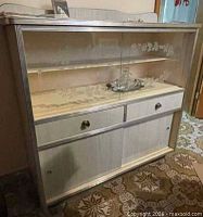 Full view of cabinet showing glass upper section, drawers and lower sliding doors