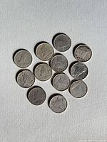 13 coins reverse sides with Bluenose schooner visible