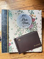 Front of large floral photo album and Black's wallet album