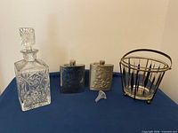 Full lot showing decanter, two flasks, funnel, ice bucket