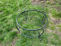 Circular cast iron stand and matching dome screen on grass