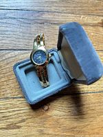 Watch in open grey velour box