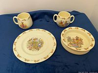 Four Bunnykins dishes arranged – two cups, plate, bowl
