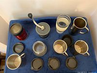 Top view of all mugs, grinder, lids and jars