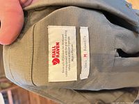 Inner label showing Fjallraven branding, size M, relaxed fit