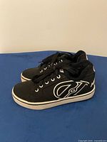 Side view of both shoes showing logo and condition