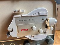 Close-up of Brownie 500 projector lens housing and control knobs