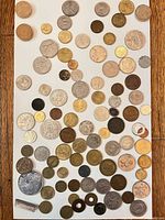 Full spread of assorted world coins on white background
