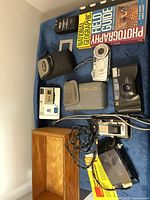 Overview of cameras, accessories, book, pouches and wooden box