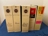 Front view of five Kodak Carousel slide tray boxes showing labels and capacities