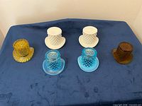 All six Fenton glass top hat vases arranged for overview