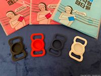 Front of three sealed towel packs and four Airtag holders